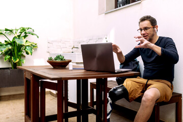 Man with Prosthetic Leg Engaging in a Video Conference Call