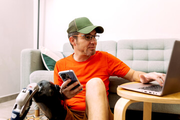 Man With Prosthetic Leg Using Devices in Comfortable Setting