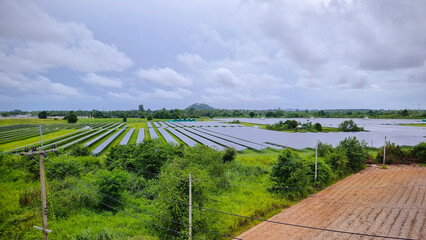 Solar cell panels and wind turbines in sunset sky for alternatively power generator source, renewable energy for future power supply and eco-friendly with environment