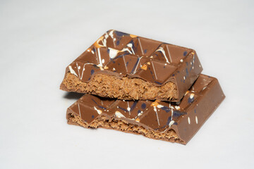Trend Dubai chocolate bar with nutella and kataifi dough filling on white background. Confectionery...