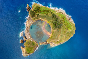 Azores aerial amazing view. Top view of Islet of Vila Franca do Campo. Crater of an old underwater volcano. San Miguel island, Azores, Portugal. Heart carved by nature. Bird eye view.