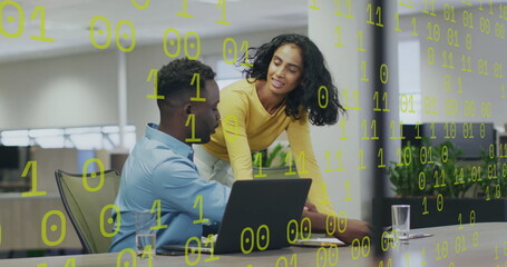 Image of binary coding over diverse colleagues discussing work
