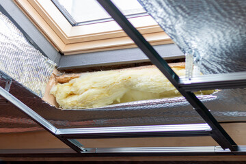 Installing skylight windows in mansard garret, or attic. Installation of suspended ceilings, thermal insulation,  vapor-permeable foil.  Roofer and window master work.
