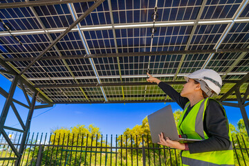 ngineer inspecting solar panel installation on a modern structure, pointing to details while...