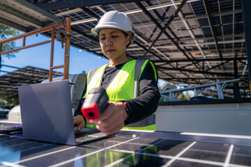 Engineer inspecting solar panels with a laptop, showcasing modern technology and innovation in...