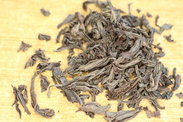 Dried Black Tea Leaves Are Artistically Arranged on a Beautiful and Rustic Wooden Surface