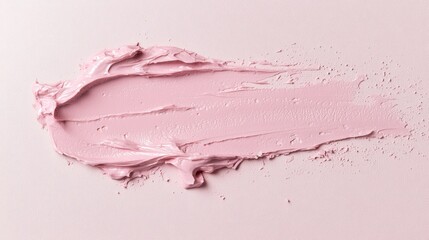 Fototapeta premium A smooth, pink paint swatch spread across a light background, showcasing texture and color.