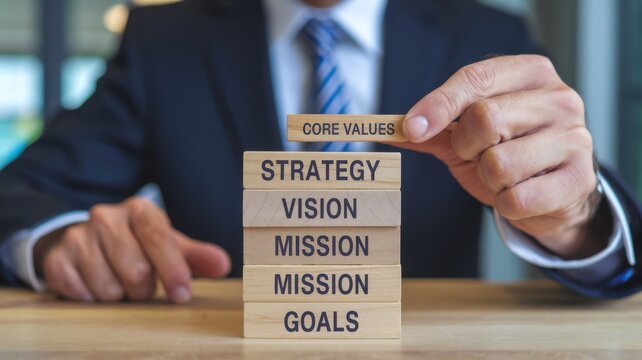 A business professional stacking blocks labeled with strategic concepts for organizational planning.