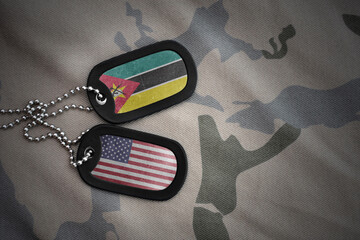 army blank, dog tag with national flag of mozambique and united states of america on the khaki...