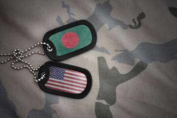 army blank, dog tag with national flag of bangladesh and united states of america on the khaki...