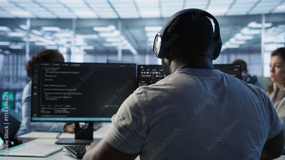 Poster system administrator working in computer network security data center listening music. african ameri