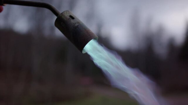 Lighting a propane gas blowtorch to employ yakisugi wood charring technique