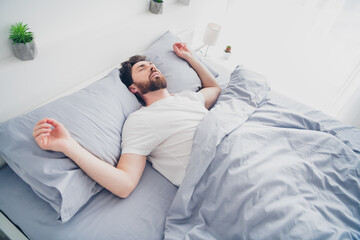 Photo of funny mature guy dressed sleepwear lying bed sleeping deeply indoors room home house
