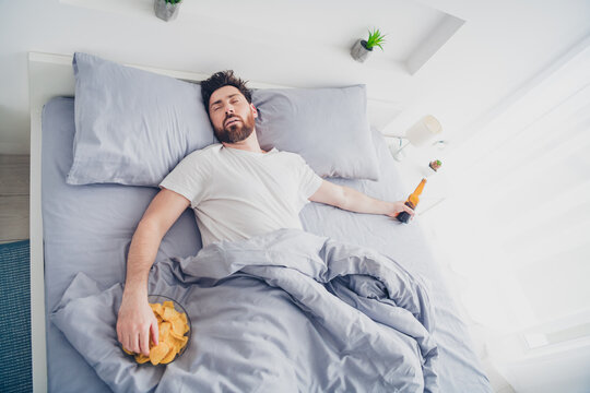 Photo of funny mature guy sleepwear pajama lying bed sleeping after hagover indoors home house bedroom