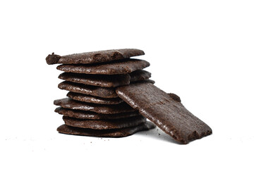 A pile of crispy chocolate brownies crackers  isolated on a white background. Right view.