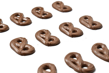 Close up view of chocolate pretzels milk isolated on white background.