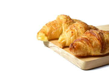Close up view of three Freshly baked mini croissants on the wooden cutting board. Fresh croissant bread isolated on the white background. Copy space, empty space, free space.
