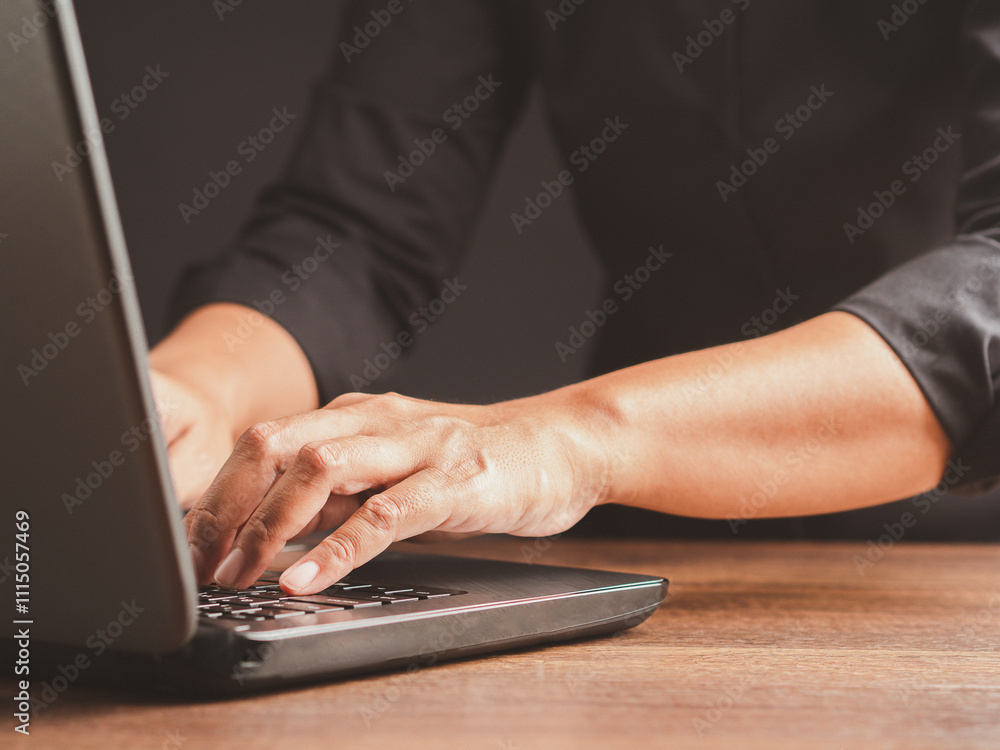 Poster hands typing on a laptop keyboard, close-up view of a professional at work.