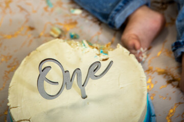 Baby boy,  celebrates his first birthday with a cake smash