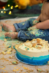 Baby boy,  celebrates his first birthday with a cake smash