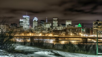 Obraz premium Nighttime city skyline with illuminated buildings and a snowy foreground.