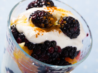 Healthy dessert with yogurt, fresh blueberries and orange