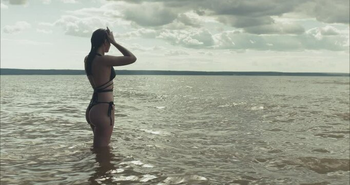 Young model posing in the water at the beach