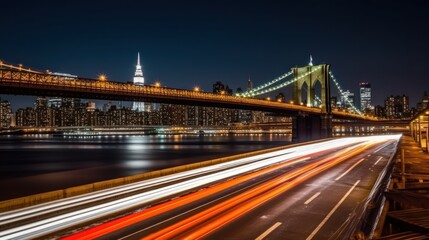 Night view of a city skyline with illuminated bridges and light trails from vehicles.