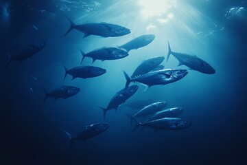 Obraz premium A mesmerizing underwater scene with a vibrant school of fish swimming in the deep blue ocean, showcasing marine biodiversity and the beauty of aquatic life.