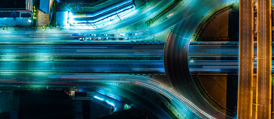 Expressway top view, Road traffic an important infrastructure, car traffic transportation above intersection road in city night, aerial view cityscape of advanced innovation, financial technology 