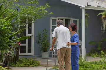 Caregiver holding gait belt for help support patient stand and walk in home.