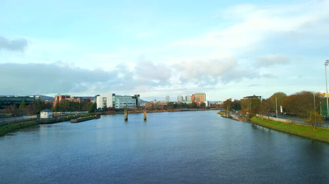 Aerial shot of the River Lagan, Belfast on a crisp autumm day. The camera moves towards Belfast City, over the Ormeau Embankment. Produced in 4K, 50fps and in Rec709 color space.