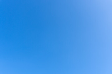 Low angle view and full frame of beautiful blue sky without clouds in the morning or evening used as natural background texture in decorative art work.