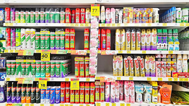 Supermarket Shelf With Insecticide Cans: Rows of colorful cans of insecticide displayed on a supermarket shelf. Thailand, December 4, 2024