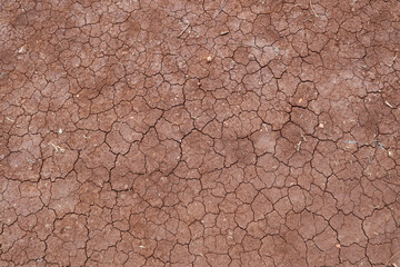 Naklejka premium Texture of cracked ground, the dried earth with clay and sand, dry mud, broken texture. Concept of drought and global warming.