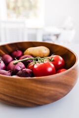 fruit bowl with tomatoes potatoes and red onions, abundance of simple natural healthy ingredients