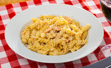 Appetizing pasta with salmon and spices with cream sauce. High quality photo