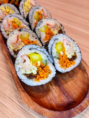 Korean dish pieces made from rice, vegetables, fish and meat rolled in sheets of dried seaweed commonly called gimbap or kimbap