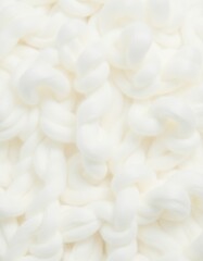 A close-up of soft, fluffy cotton fibers, ready for spinning.