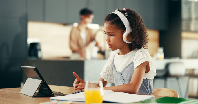 Girl, tablet and education with studying in kitchen for elearning, video or headphones for online course. Child, notebook and touchscreen with point, scholarship and school project in family house