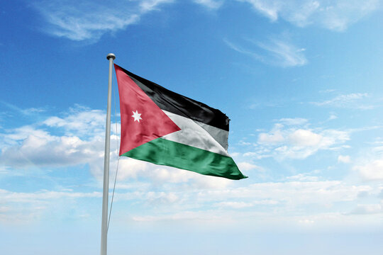 Waving flag of Jordan in blue sky. Jordan flag for Republic Day and Independence Day.