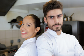 Obraz premium two smiling chefs in a kitchen