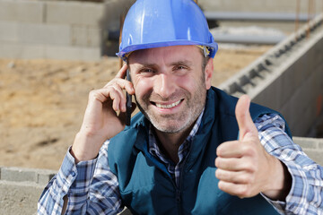 happy male construction showing thumb up
