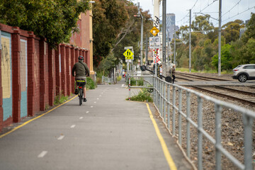 sydney road melbourne with a traffic jam with people walking and riding bike in a melbourne...
