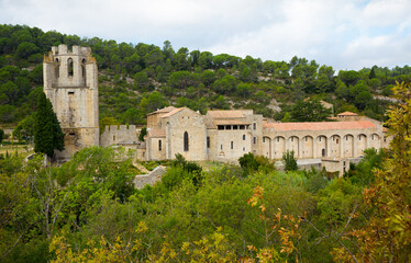 Obraz premium View of Romanesque Benedictine Abbey Sainte-Marie d'Orbieu with bell tower in commune of Lagrasse, France