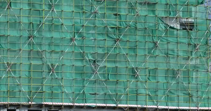 Construction site safety netting sways in the wind