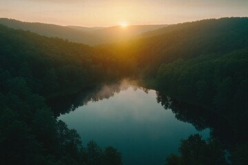 Serene Sunrise Over Misty Forest Lake with Reflections and Hills