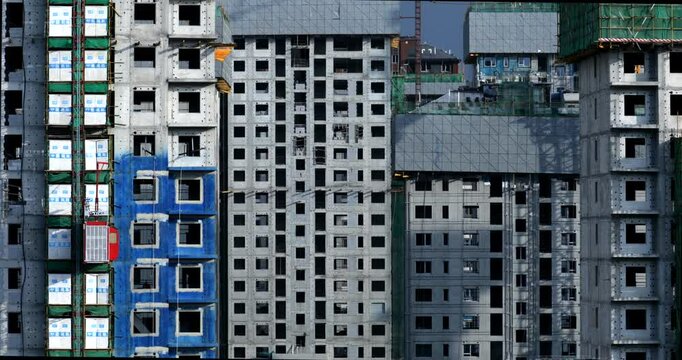 Construction site, in progress. Unfinished building and Elevator is moving