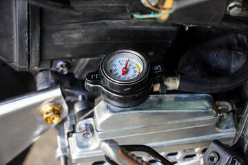 Fototapeta premium Detailed image of a motorcycle's temperature gauge. Shows precision engineering and mechanical details. Close-up of a Motorcycle's Temperature Gauge.