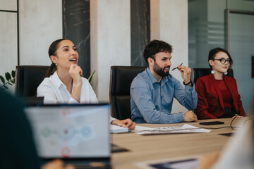 A diverse group of people actively participating in a collaborative business meeting, showcasing...